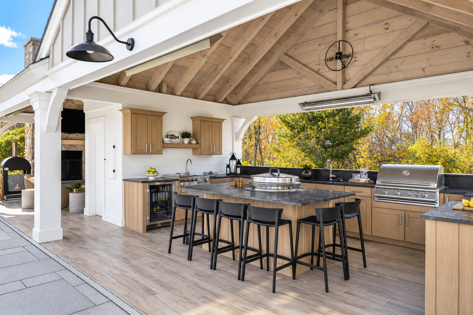 Outdoor kitchen featuring NatureKast weatherproof cabinetry, built-in grill and stone countertops. 